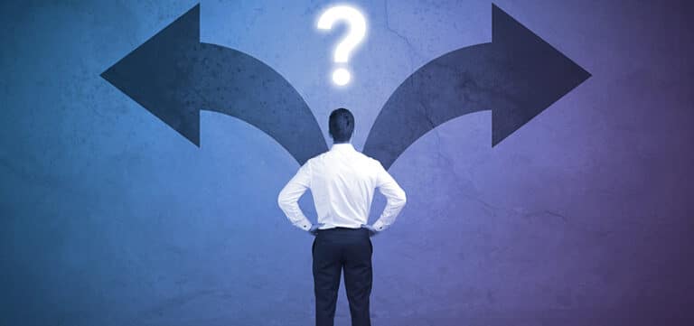 A person stands facing a wall with two large arrows pointing in opposite directions and a question mark above, symbolizing a decision or choice to be made.