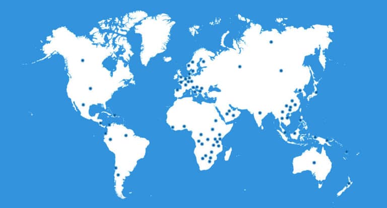A world map with blue dots evenly distributed across continents on a blue background.