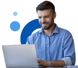 Man in a blue shirt smiles while using a laptop, with blue graphic circles in the background.