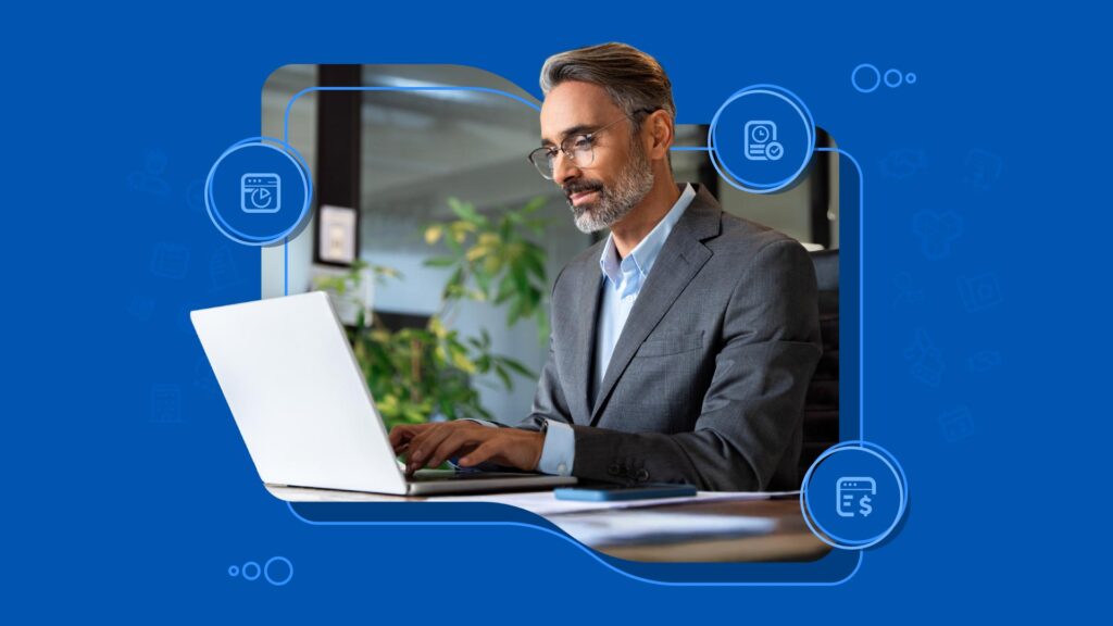 A man in a gray suit working on a laptop at a desk, surrounded by icons on a blue background.